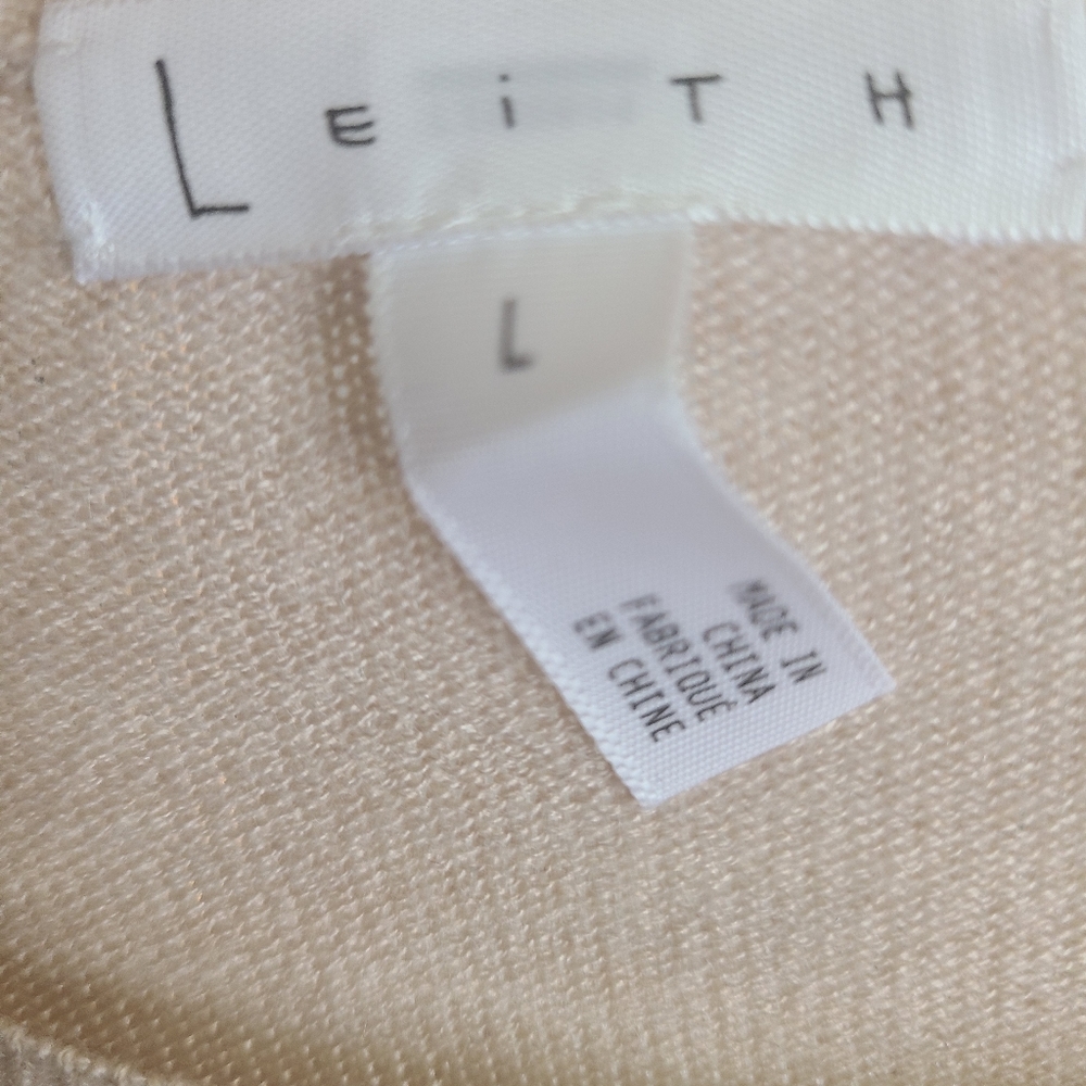 Light tan bell sleeve cotton sweater.